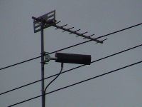 A can-tenna mounted on a television antenna pole.
