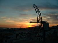 Parabolic wireless 802.11b antenna mounted in Tarifa with evening Sun as backdrop