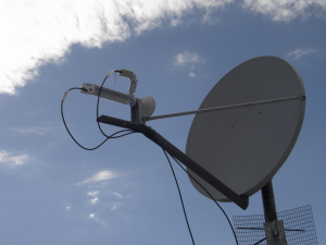 Satellite dish and wireless antenna mounted on outside communications vehicle